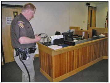Court officer checking assistive listening devices
