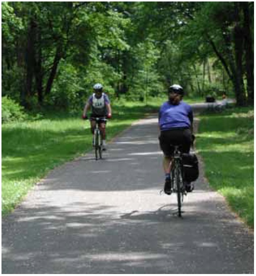 Figure 20: Photo. Trail users consisted of both active and in situ participants. There are two bicyclists riding on this trail. One is wearing a bib with a number on it, indicating that he is an active participant. The other is not wearing a bib, indicating that he is an in situ participant. 