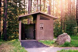 An accessible outdoor restroom facility at Lee Creek Campground