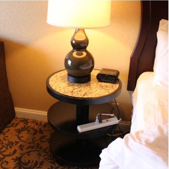 Nightstand with power strip, clock, and lamp