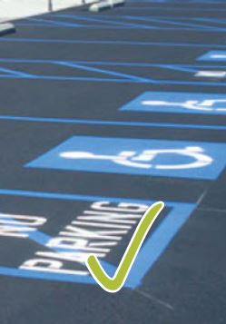 Accessible parking spaces with a green check mark on the bottom of the image, indicating an accessible element