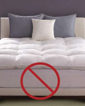 a white bed with a red circle with a line through it at the bottom of the image, indicating a non-accessible bed