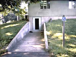 Photo of an alternative parking space and ramp at a different entrance to the building