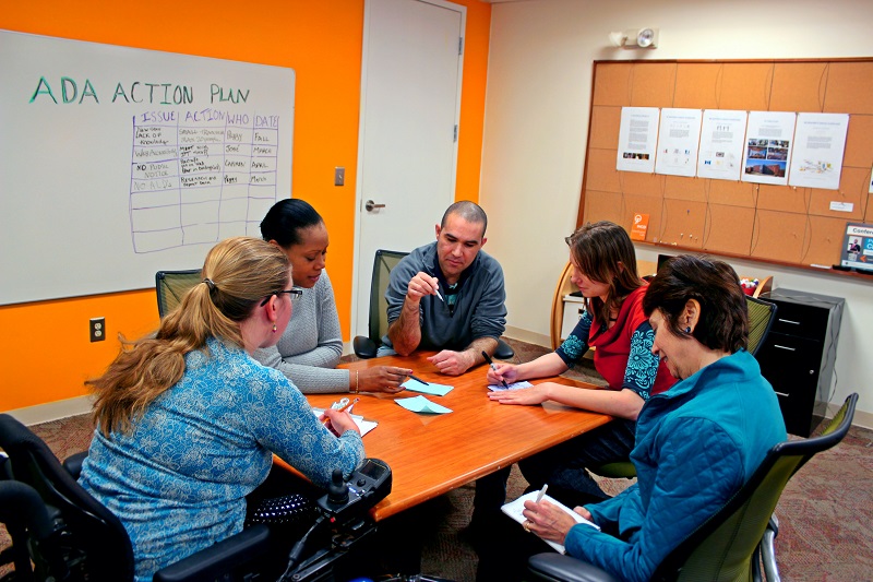 Five people working on an action plan