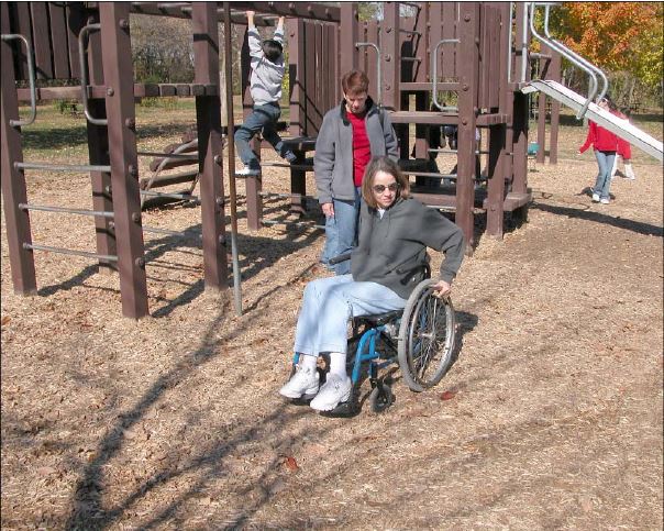 woman in a wheelchair on a playground