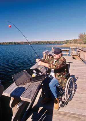 Man in a wheelchair fishing