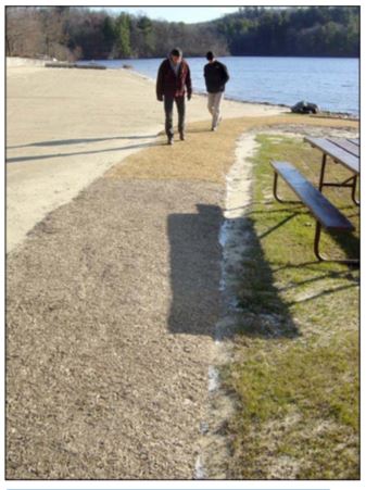 Figure 7-Beach path after 2 months of weathering. Junction of Soil-Sement and Vitri-Turf surfaces is just above the shadow cast by the picnic bench. 