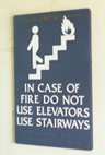 Sign used at elevators that says: "In case of fire do not use elevators, use stairs."