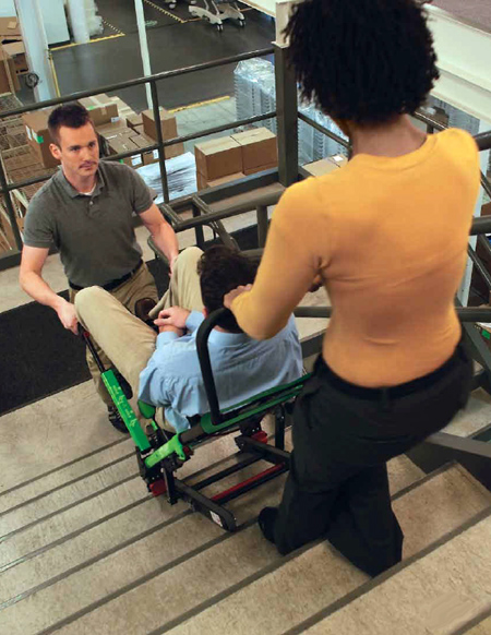 Woman and a man assisting another man down the stairs with an "emergency stair descent device.