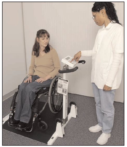 patient in wheelchair being weighed on an accessible scale
