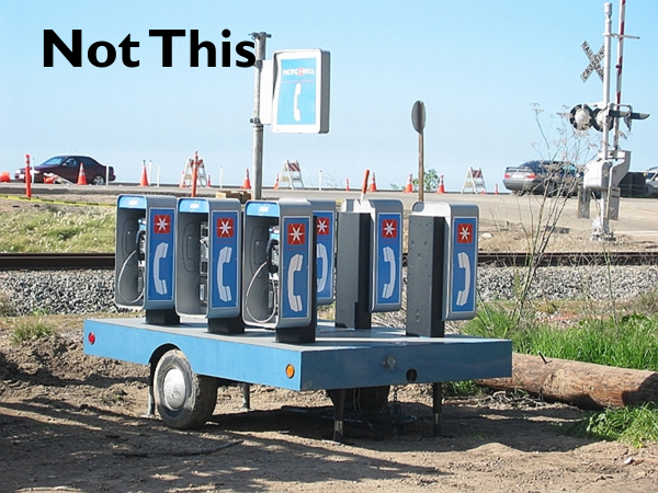Six portable pay phones mounted on a trailer, all with inaccessible reach ranges