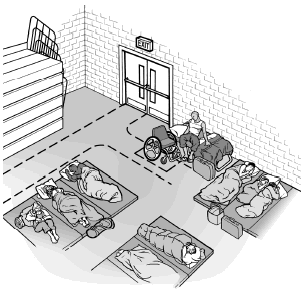 A individual who uses a wheelchair sits on a cot that is placed against a wall. The height of the bed and the wheelchair seat are of similar height making it possible for this person to transfer from the wheelchair to the bed.