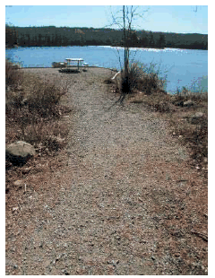 Dense grade gravel trail to lake and picnic area.