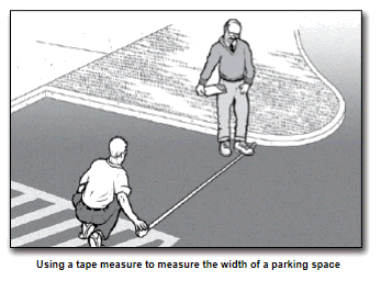 two men measure width of vehicle space
