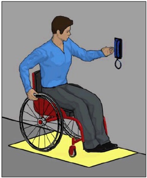 Person using wheelchair positioned for side reach to wall-mounted phone