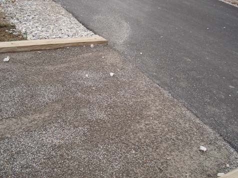 Stabilizer segment with small fines meets asphalt path.