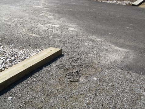 Stabilizer shows some runoff into asphalt segment.