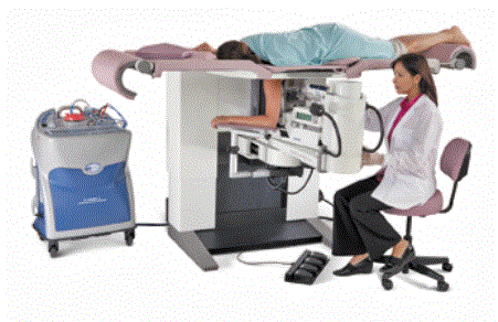Photograph of patient on a prone breast biopsy table while physician works underneath the table.