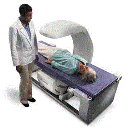 Picture shows a Dual Energy X-ray Absorptiometry (DXA) system for Osteoporosis assessment with a patient lying on the scanning bed. A technician is standing beside the equipment. The table heights are fixed due to the diagnostic need for a fixed geometry. The table heights are typically 25 - 28 inches and are dictated by the needing the X-Ray source below the table for diagnostic and radiation dose considerations. Also note the equipment imaging components on the opposite side of where the patient transfers.