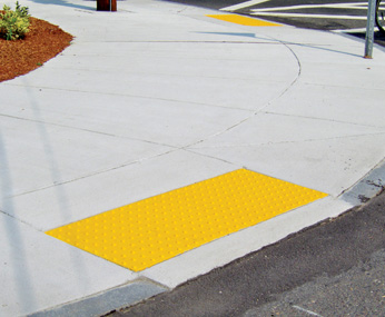 Perpendicular curb ramp with yellow detectable warnings