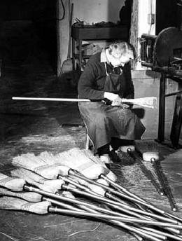 Person making brooms, c. 1940