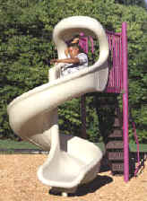 photo of a boy on a spiral slide