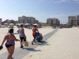 people walking on a boardwalk beach access walkway